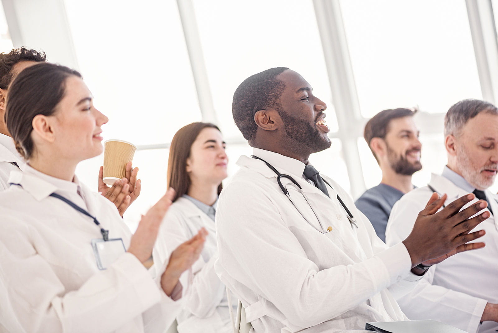 Medical professionals clapping meeting