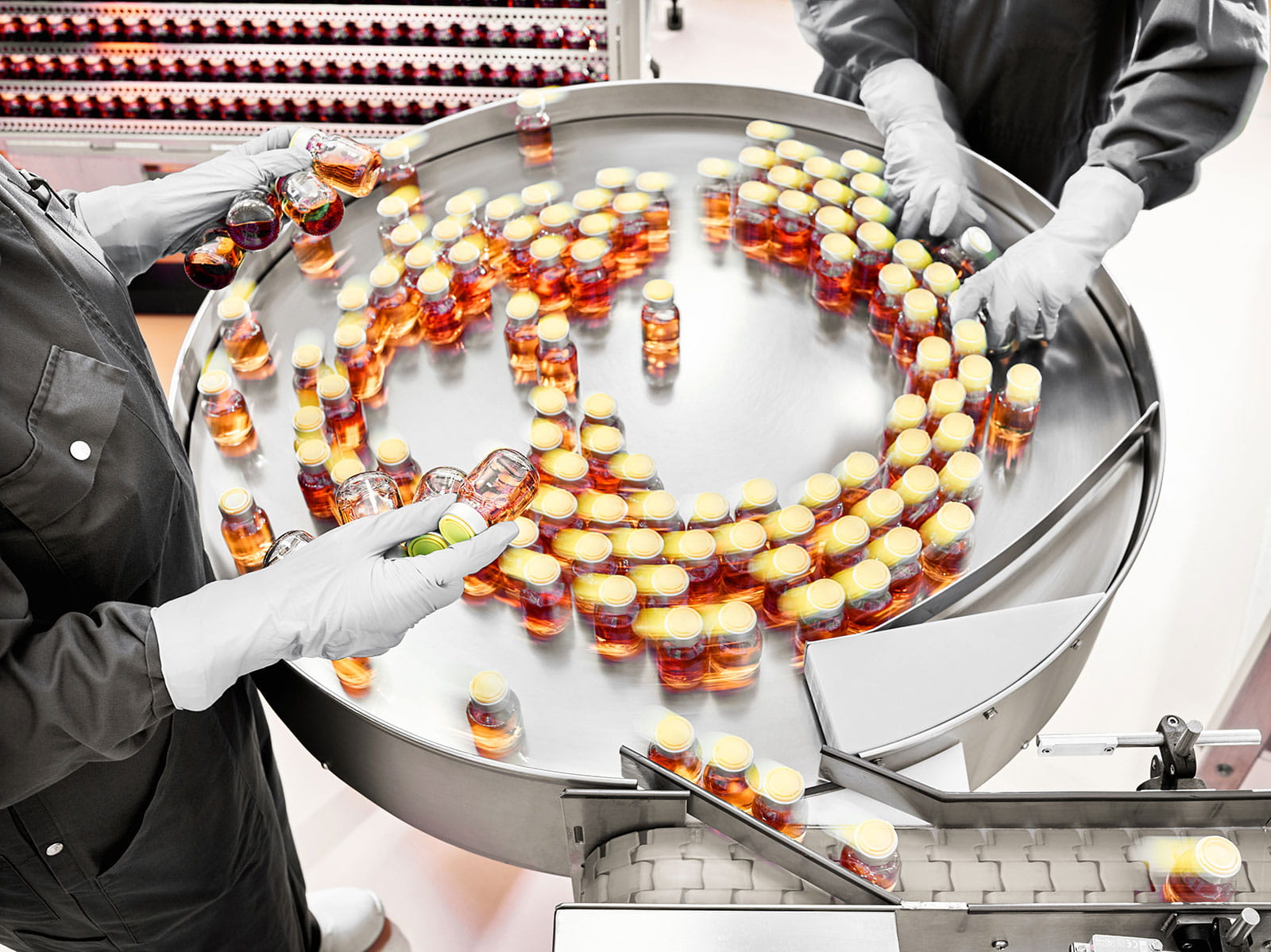 photo of gloved employees handling many product bottles